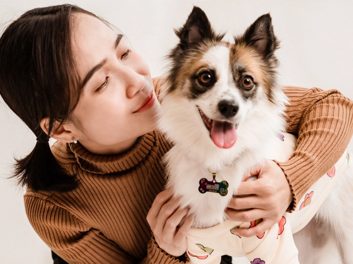 Smiling woman bonding with her pet dog